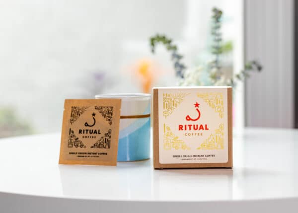 Box of single origin instant coffee on white table