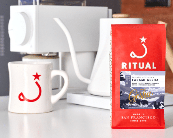 Ritual coffee bag with mug, kettle, and grinder in the background