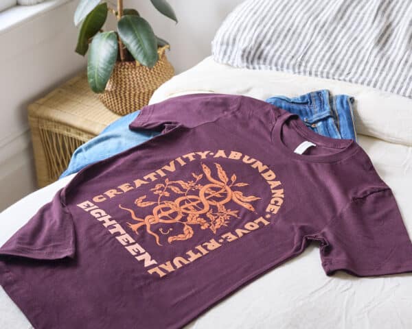 Shirt and jeans on top of a bed