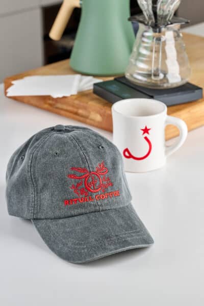 6-Panel hat and mug on table