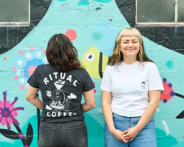Two models wearing the roaster shirt in black and white