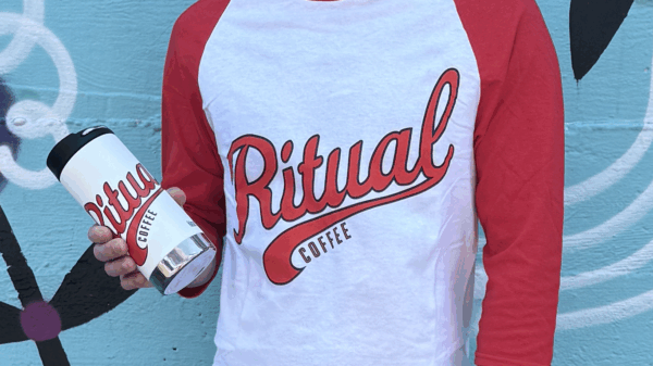Model holding 12oz sports tumbler