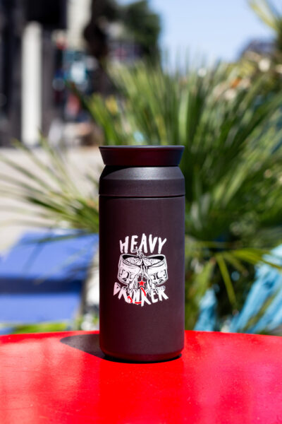 A black tumbler that says "heavy drinker"